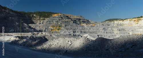 Panorama of a quarry for limestone mining in the morning contrast illumination.