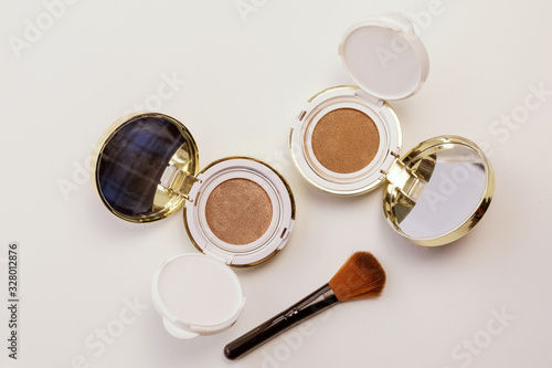 Makeup powder, brush. Professional cosmetics background.