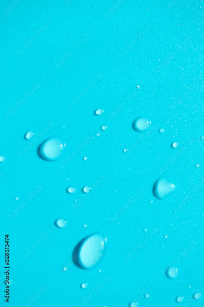 Water drops with copy space on blue background, top view. Vertical