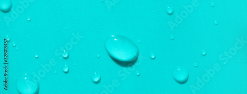 Wallpaper Mural Close-up water drops on turquoise colored background, top view. Banner format backdrop Torontodigital.ca