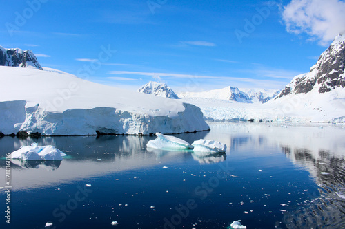 Landscape of snowy mountains and icy shores of the Lemaire Channel in the Antarctic Peninsula  Antarctica
