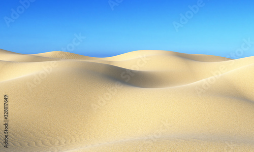 Smooth sand dunes under blue sky