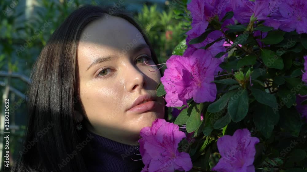 Young woman with flowers, close-up Young woman with flowers, close-up