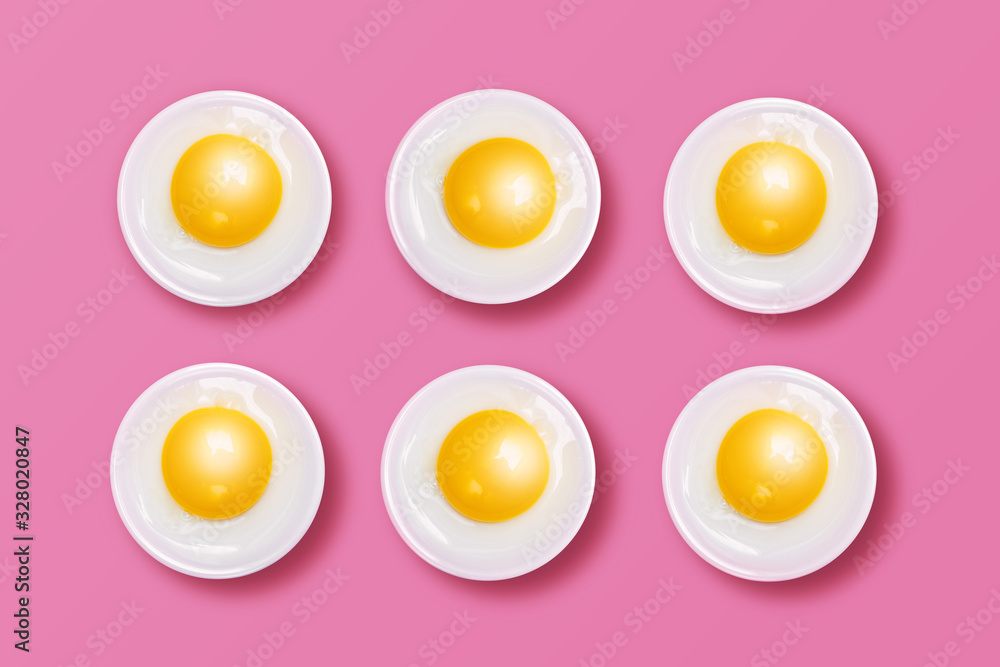 Eggs - Yellow Yolks and White Albumens on Pink Background Eggs - Yellow Yolks and White Albumens on Pink Background