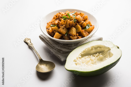 Kaccha Papita Sabji or Raw Papaya Sabzi, served in a karahi or bowl. selective focus photo