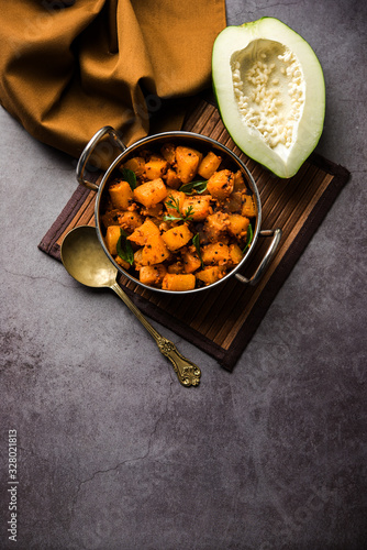 Kaccha Papita Sabji or Raw Papaya Sabzi, served in a karahi or bowl. selective focus photo