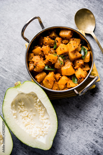 Kaccha Papita Sabji or Raw Papaya Sabzi, served in a karahi or bowl. selective focus photo