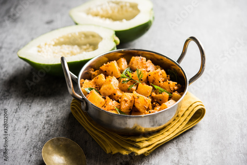 Kaccha Papita Sabji or Raw Papaya Sabzi, served in a karahi or bowl. selective focus photo