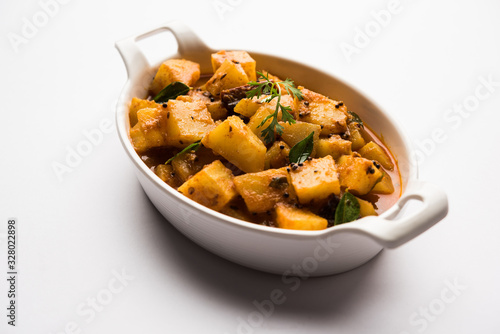 Kacha Papita sabzi with gravy or Raw Papaya curry Sabji , served in a bowl. selective focus