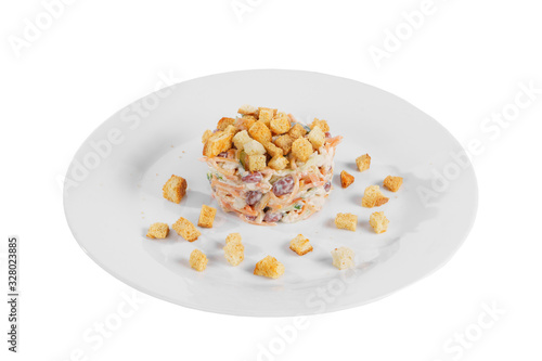 salad with beans, Korean carrots, cucumber, chicken, crackers on plate, white isolated background Side view. For the menu, restaurant, bar, cafe