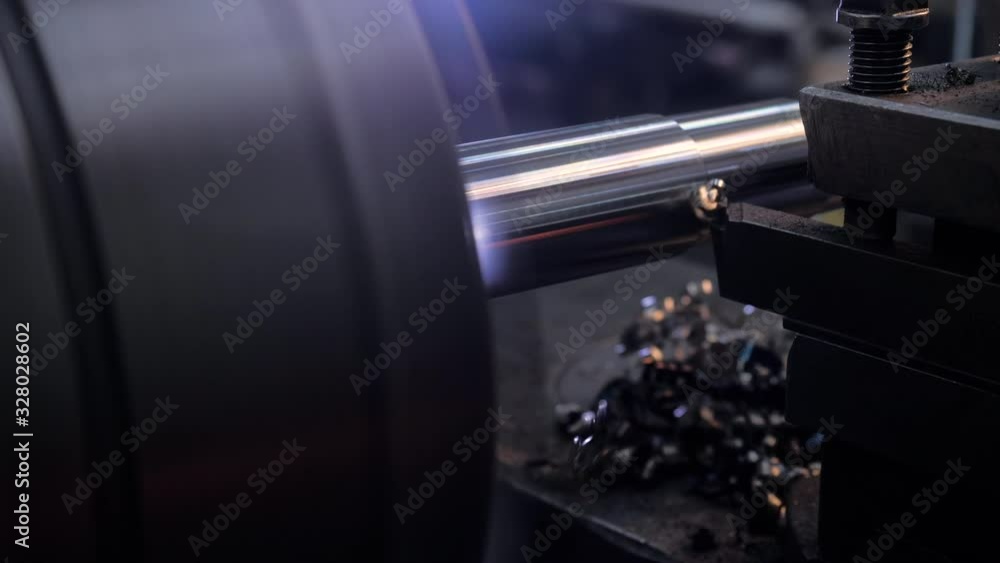 Automation process of cut metal on lathe machinery on factory production closeup. Workshop of steel detail or milling parts indoors. Tech making use cnc drill tool, modern equipment of heavy industry Automation process of cut metal on lathe machinery on factory production closeup. Workshop of steel detail or milling parts indoors. Tech making use cnc drill tool, modern equipment of heavy industry
