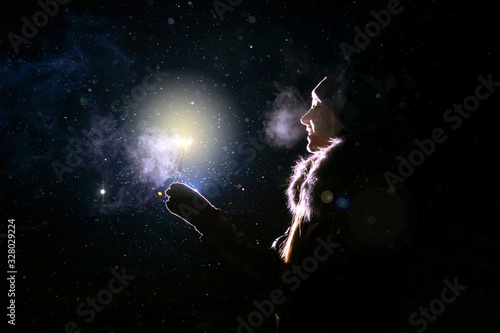 Profile of girl with sparkler in dark. © Татьяна Максимова