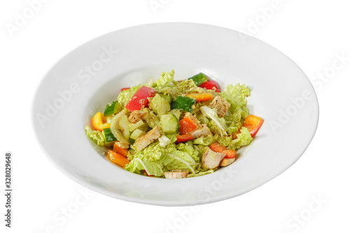 Caesar salad with pieces of chicken breast, tomato, bell pepper, cucumber, lettuce, walnuts on plate, white isolated background Side view. For the menu, restaurant, bar, cafe