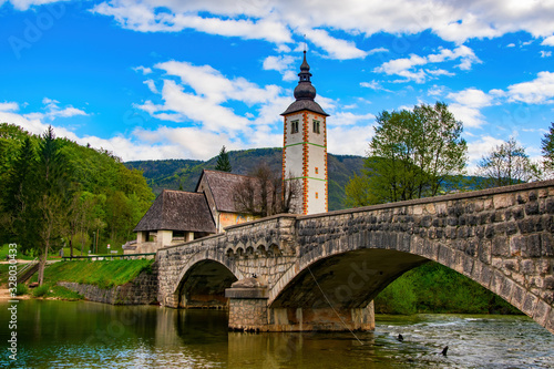 Scenic view of stone bridge and church of St John the Baptist on Bohinj Lake, Slovenia
