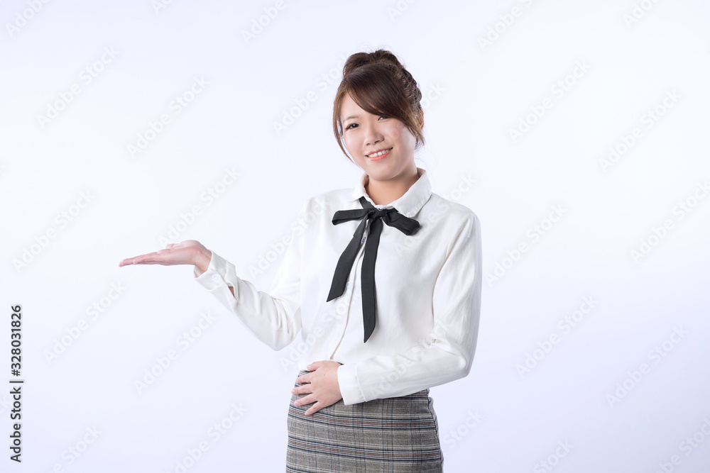 A smiling young girl demonstrate something isolated on white background. A smiling young girl demonstrate something isolated on white background.