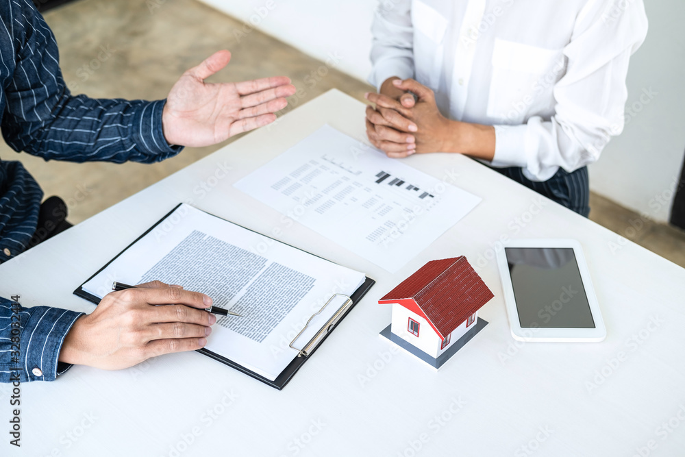 Real estate broker agent being analysis and making the decision a home estate loan to customer to signing contract documents for realty purchase, Bank employees recommend mortgage loan approval Real estate broker agent being analysis and making the decision a home estate loan to customer to signing contract documents for realty purchase, Bank employees recommend mortgage loan approval