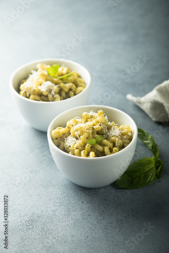 Pasta with pesto sauce served for two