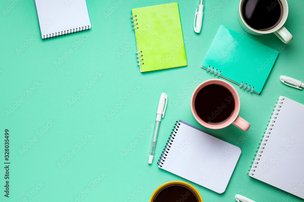 mint green background copy space with work accessories such as notebook, pens, coffee mint green background copy space with work accessories such as notebook, pens, coffee