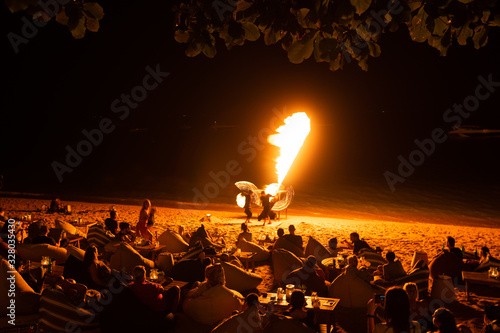 Fire show on the beach on Koh Samui in Thailand. Dances show performance to a large number of people with fire