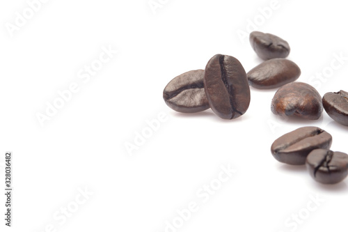 closeup piled of coffee beans group roast dark brown colour textured isolated on white backgrounds