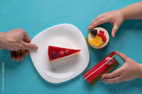 childrenâ€™ hands taking cake in the blue background,holiday