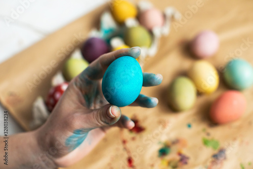 Happy Easter! Girl's hands holding Blue Easter egg