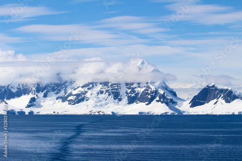 Landscape of snowy mountains and frozen coasts along the Danco Coast in the Antarctic Peninsula, Antarctica
