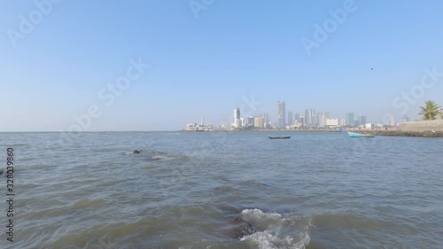 Low angle shot of beautiful city skylines over the sea and Haji Ali dargah in Mumbai India photo