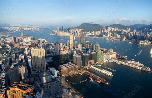 Cityscape Hong Kong city surrounded by hill silhouettes © Yan