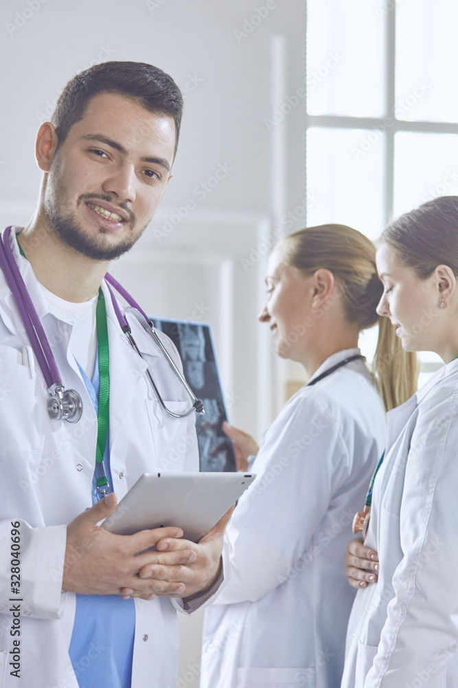 Team of doctors watching x-ray image in a hospital Team of doctors watching x-ray image in a hospital