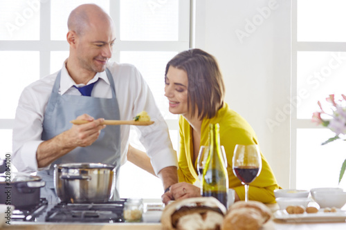 Smiling young couple cooking food in the kitchen