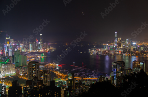 Cityscape Hong Kong city buildings surround wide harbour © Yan