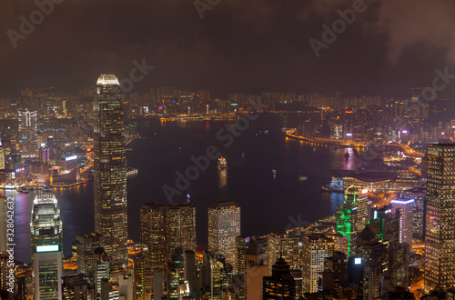 Cityscape buildings illumination reflected in Hong Kong bay