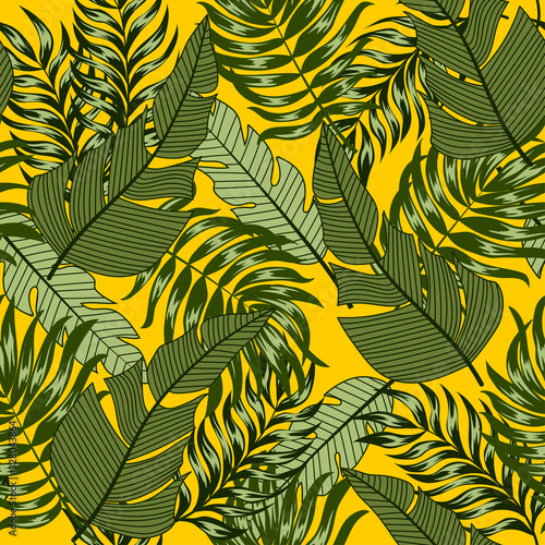 Botanical seamless tropical pattern with bright plants and leaves on a yellow background. Tropic leaves in bright colors. Trendy summer Hawaii print.
