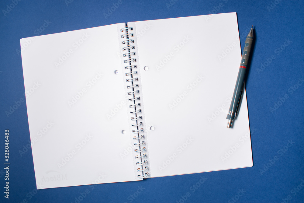 Top view of a notebook with a pen on a colorful background. Flat lay with writing space Top view of a notebook with a pen on a colorful background. Flat lay with writing space