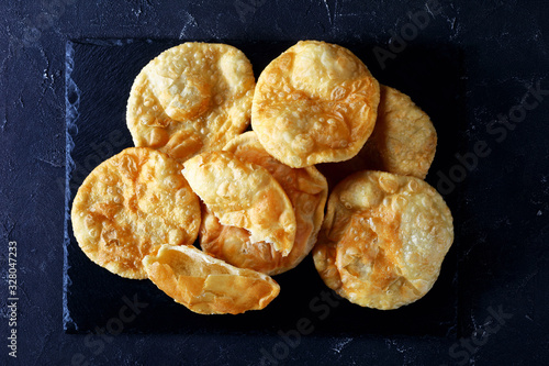 Bhatura on a black tray, flat lay photo