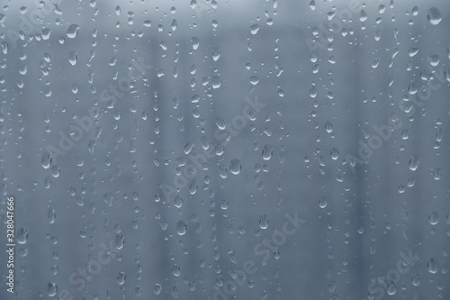 raindrops on glass window and background with buildings