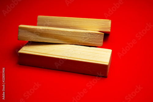Three wood blocks on a red background