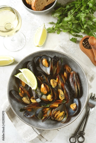Fresh sea mussels in white wine with onions, garlic and cilantro. Healthy food.