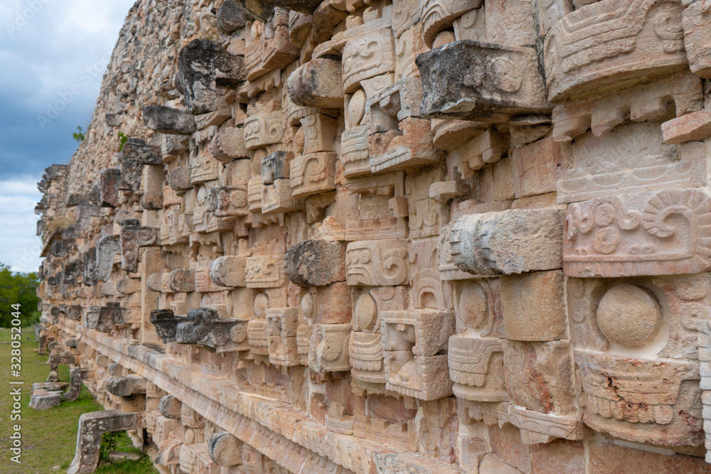 Traditional Mayan symbols. Fragment of palace of the Masks (Codz Poop) in Kabah Mayan archaeological site. Yucatan. Mexico.