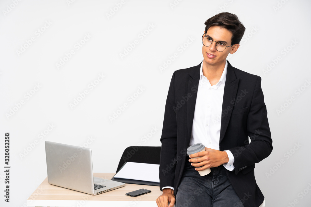 Businessman in his office over isolated white background standing and looking to the side Businessman in his office over isolated white background standing and looking to the side
