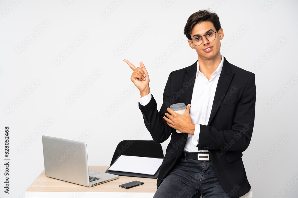 Businessman in his office over isolated white background pointing finger to the side Businessman in his office over isolated white background pointing finger to the side