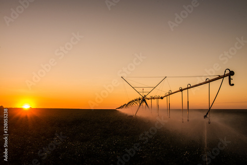 Agriculture - Aerial image, Pivot irrigation used to water plants on a farm. sunset, circular pivot irrigation with drone - Agribusiness photo