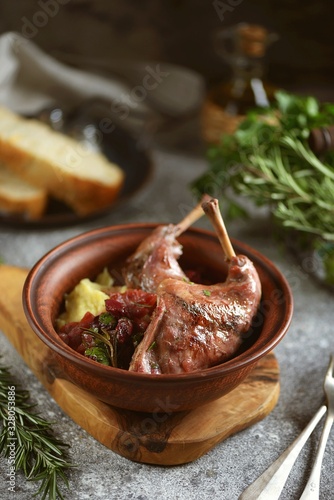 Rabbit stewed in wine with vegetables, rosemary and cherry.