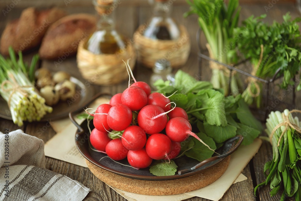 Fresh spring radish with wild garlic parsley and quail eggs on a wooden background. Ingredients for the salad. Fresh spring radish with wild garlic parsley and quail eggs on a wooden background. Ingredients for the salad.