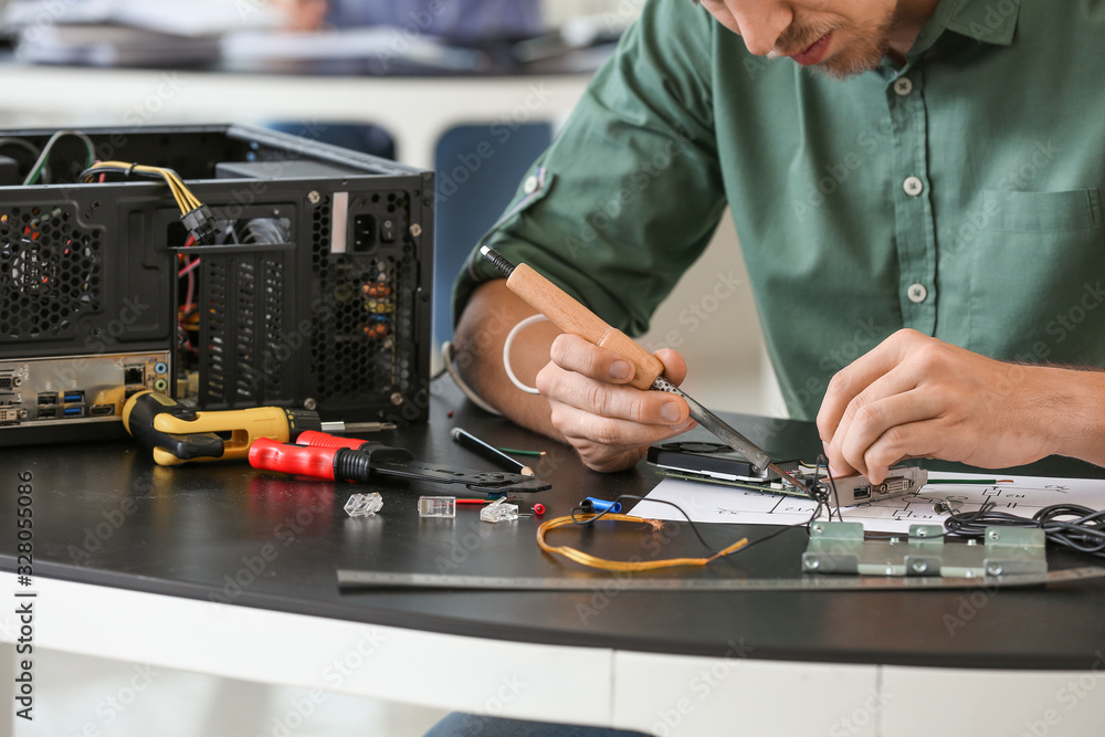 Electronic technician working in service center Electronic technician working in service center
