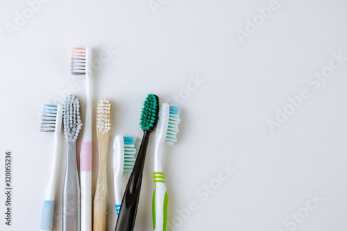 Different types of toothbrushes on a white background with copy space. dental care concept
