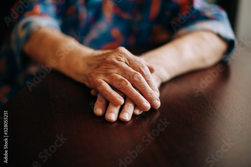 Hands of Real senior woman at home