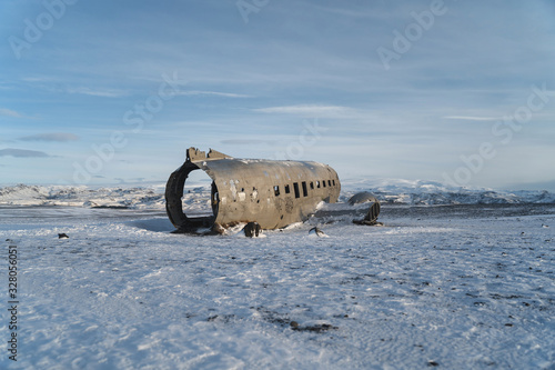 Wreck of Old Plane on Icelandic Black Sand Beach. Amazing Landscape Background.