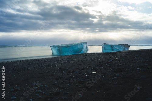 Jokulsarlon Glacier Lagoon in Iceland. Black Sand Beach with Huge Iceberg. Icelandic Cold Winter. Beautiful Nature Background.